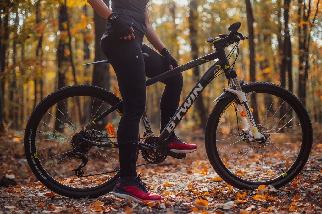 person riding black and red mountain bike